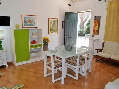 a living room with a white table and chairs at CASE VACANZA PERLA DEL SUD in San Vito lo Capo