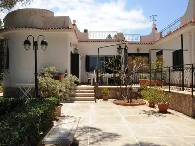 a house with a patio and stairs in front of it at CASE VACANZA PERLA DEL SUD in San Vito lo Capo