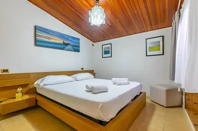a bedroom with a bed with two towels on it at GuestHost - Sea View Charm - Mondello Apartment with Terrace in Palermo