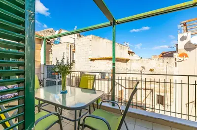 a patio with a table and chairs on a balcony at GuestHost - Sea View Charm - Mondello Apartment with Terrace in Palermo