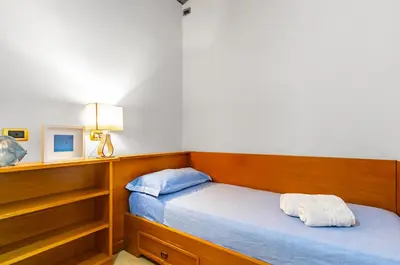 a bedroom with two beds and a television in it at GuestHost - Sea View Charm - Mondello Apartment with Terrace in Palermo