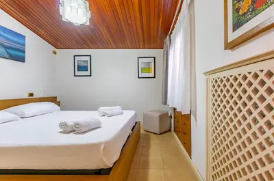 a bedroom with a bed with towels on it at GuestHost - Sea View Charm - Mondello Apartment with Terrace in Palermo