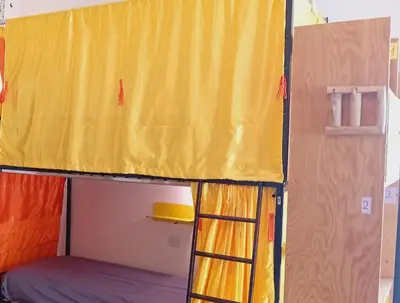 a bunk bed in a room with a yellow curtain at Ostello Exclusive Dependance in Palermo