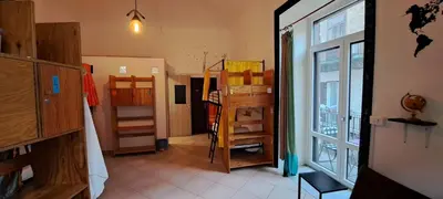 a room with a hallway with shelves and a window at Ostello Exclusive Dependance in Palermo