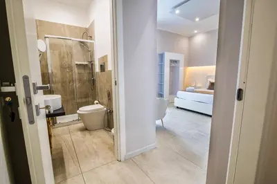 a bathroom with a toilet and a sink and a shower at My Place B&B in Carini