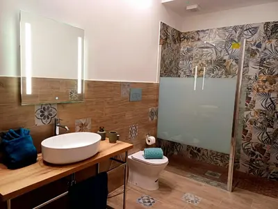 a bathroom with a sink and a toilet and a mirror at Palermo case vacanza in Palermo