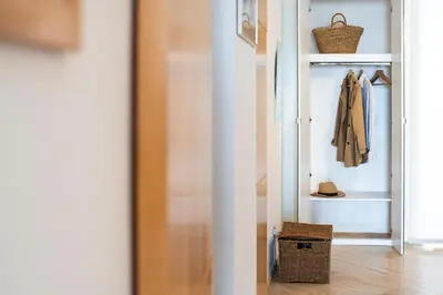 a room with a closet with a coat and a door at Studio Anatólio in Castellammare del Golfo