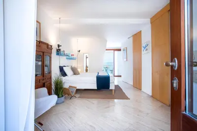 a bedroom with a bed and a couch in a room at Studio Anatólio in Castellammare del Golfo