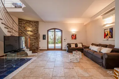 a living room with a couch and a tv at Villa DellAlbero in Alcamo