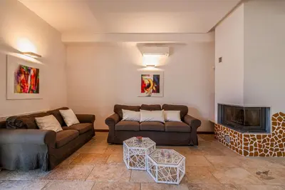a living room with two couches and a fireplace at Villa DellAlbero in Alcamo