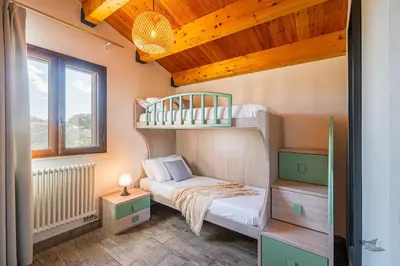 a small room with a bunk bed and a bed at Villa DellAlbero in Alcamo