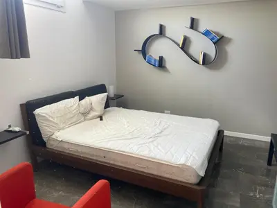 a bedroom with a bed with a sign on the wall at Casa levante in Palermo