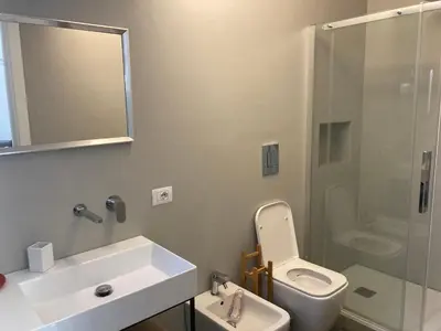 a bathroom with a sink and a toilet and a shower at Casa levante in Palermo