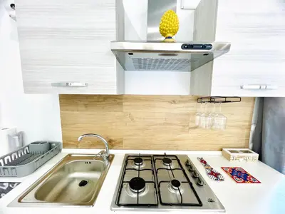 a small kitchen with a stove and a sink at Casa Nonna Anna in Palermo