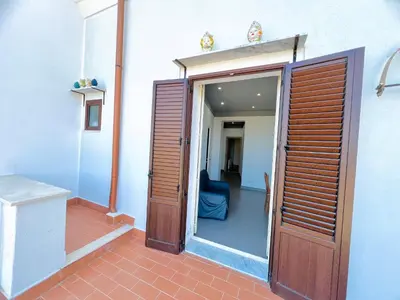 an open door to a room with a blue couch at Casa Nonna Anna in Palermo