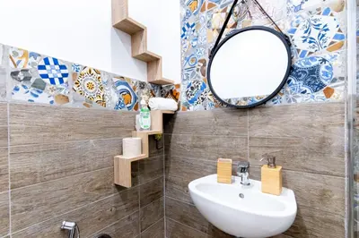 a bathroom with a sink and a mirror at Al Cortile del capo in Palermo