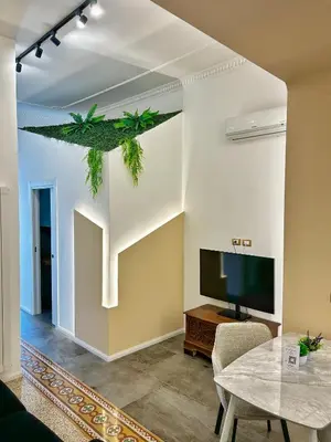 a living room with a tv and a table at Suites Cavour holiday dream in Palermo
