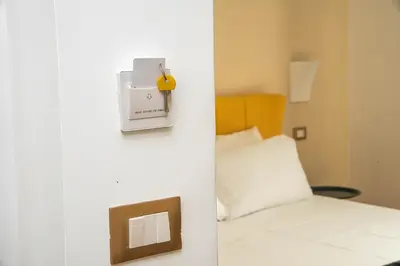 a bedroom with a bed and a clock on a wall at Suites Cavour holiday dream in Palermo
