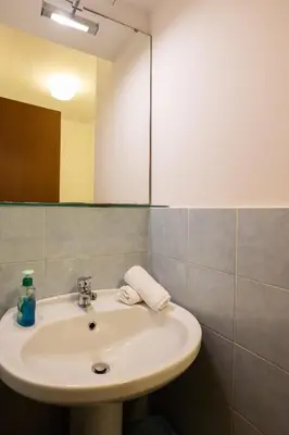a bathroom with a sink and a mirror at Hola House alla Magione in Palermo