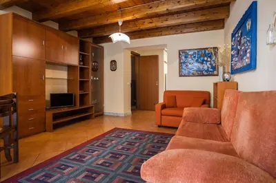 a living room with a couch and a tv at Hola House alla Magione in Palermo