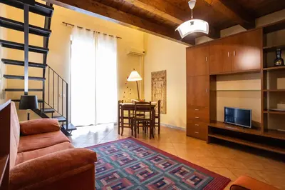 a living room with a couch and a table at Hola House alla Magione in Palermo