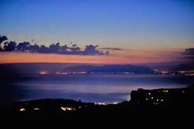 a view of the ocean at night at B&B Tre Giummare in Scopello