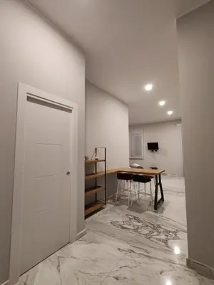 a room with a table and a white door at Lily Apartments in Palermo