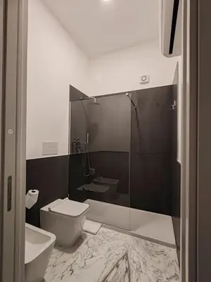 a bathroom with a toilet and a sink and a shower at Lily Apartments in Palermo