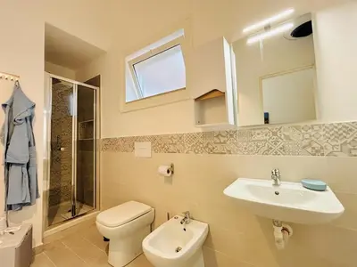 a bathroom with a toilet and a sink at Calamari37 in Palermo
