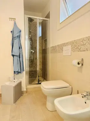 a bathroom with a toilet and a shower and a sink at Calamari37 in Palermo