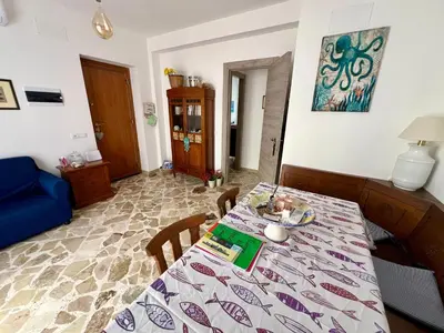 a dining room with a table with a table cloth at La casa di Gisa&Laura Lido di Mondello spiaggia in Palermo