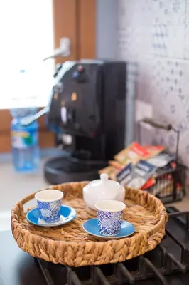 a tray with three cups and saucers on a table at Casa vacanze near airport in Cinisi