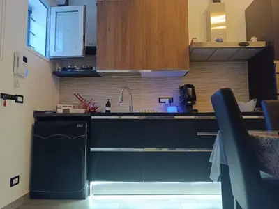 a kitchen with a black counter and a sink at Lannari 176 Casa vacanze Bagheria in Bagheria