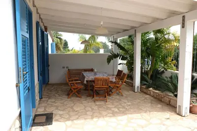 a patio with a table and chairs on it at Villa Indipendente Tranquillità e Relax in San Vito lo Capo