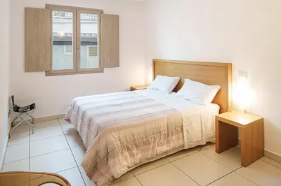 a bedroom with a large bed and a window at Capo Zafferano Apartments in Santa Flavia