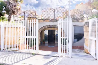 an entrance to a house with a white fence at Sofia’s Studio at Mondello in Palermo
