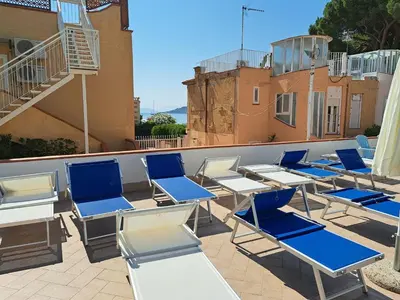 a group of chairs sitting on top of a roof at Sofia’s Studio at Mondello in Palermo