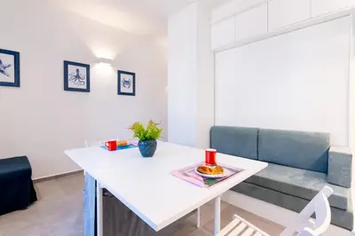 a living room with a white table and a couch at Sofia’s Studio at Mondello in Palermo