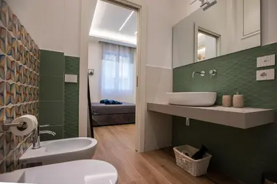 a bathroom with a sink and a toilet at Maison La Lumia in Palermo