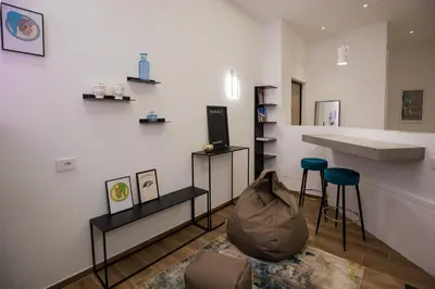 a room with two stools and a counter in a room at Maison La Lumia in Palermo