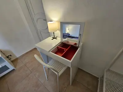 a white desk with a chair and a mirror at Terrazza Ballarò in Palermo