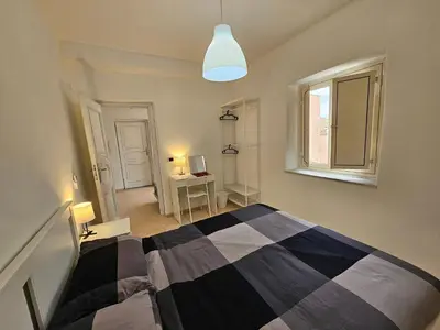 a bedroom with a black and white bed and a window at Terrazza Ballarò in Palermo