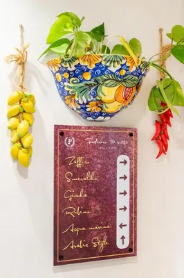 a sign in front of a bowl and a plate at Federico 70 Arabic Style in Palermo