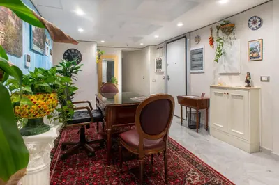 a living room with a table and chairs at Federico 70 Arabic Style in Palermo