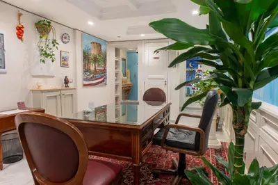 an office with a desk and a potted plant at Federico 70 Acquamarina Luxury in Palermo