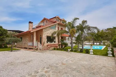 a large house with a swimming pool in front of it at Villa laura in Palermo