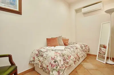 a bedroom with a bed and a mirror in it at Villa laura in Palermo