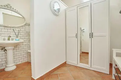 a white bathroom with a shower and a sink at Villa laura in Palermo