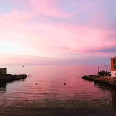 a view of a large body of water at sunset at Relaxing seahouse in Santa Flavia