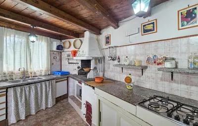 a kitchen with a sink and a stove top oven at Lovely Home In Altavilla Milicia in Altavilla Milicia